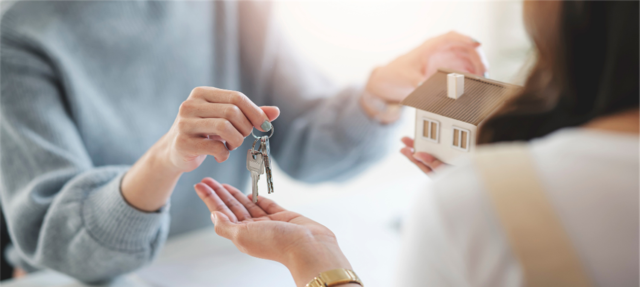 Photo of Title Closing Photo of Title Closing where two people exchange keys for a house